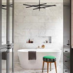 modern bath with chunky upholstered stool